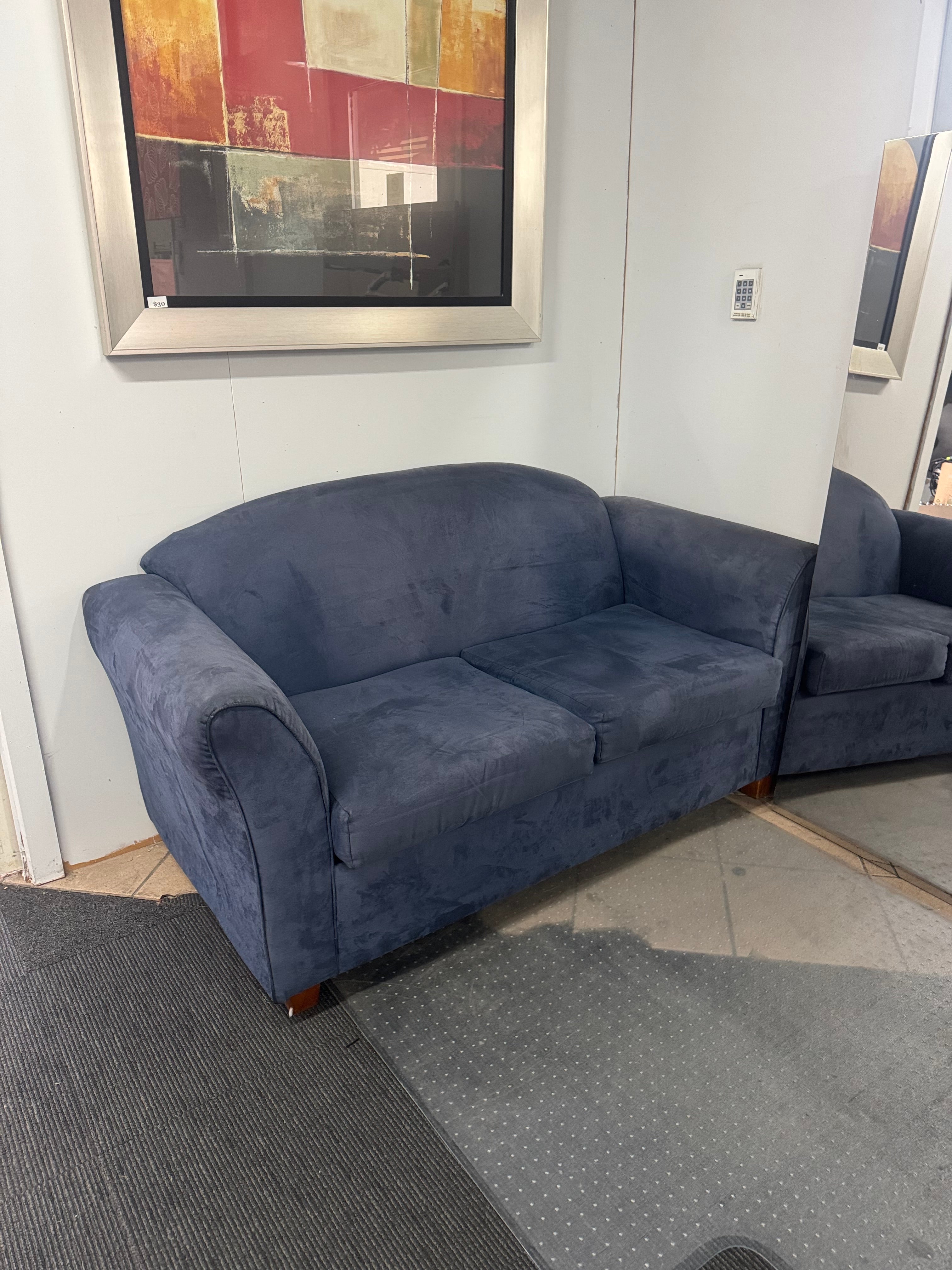 Gray sofa in a room with a painting on the wall