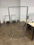 Clear plastic screen with metal frame in an office setting