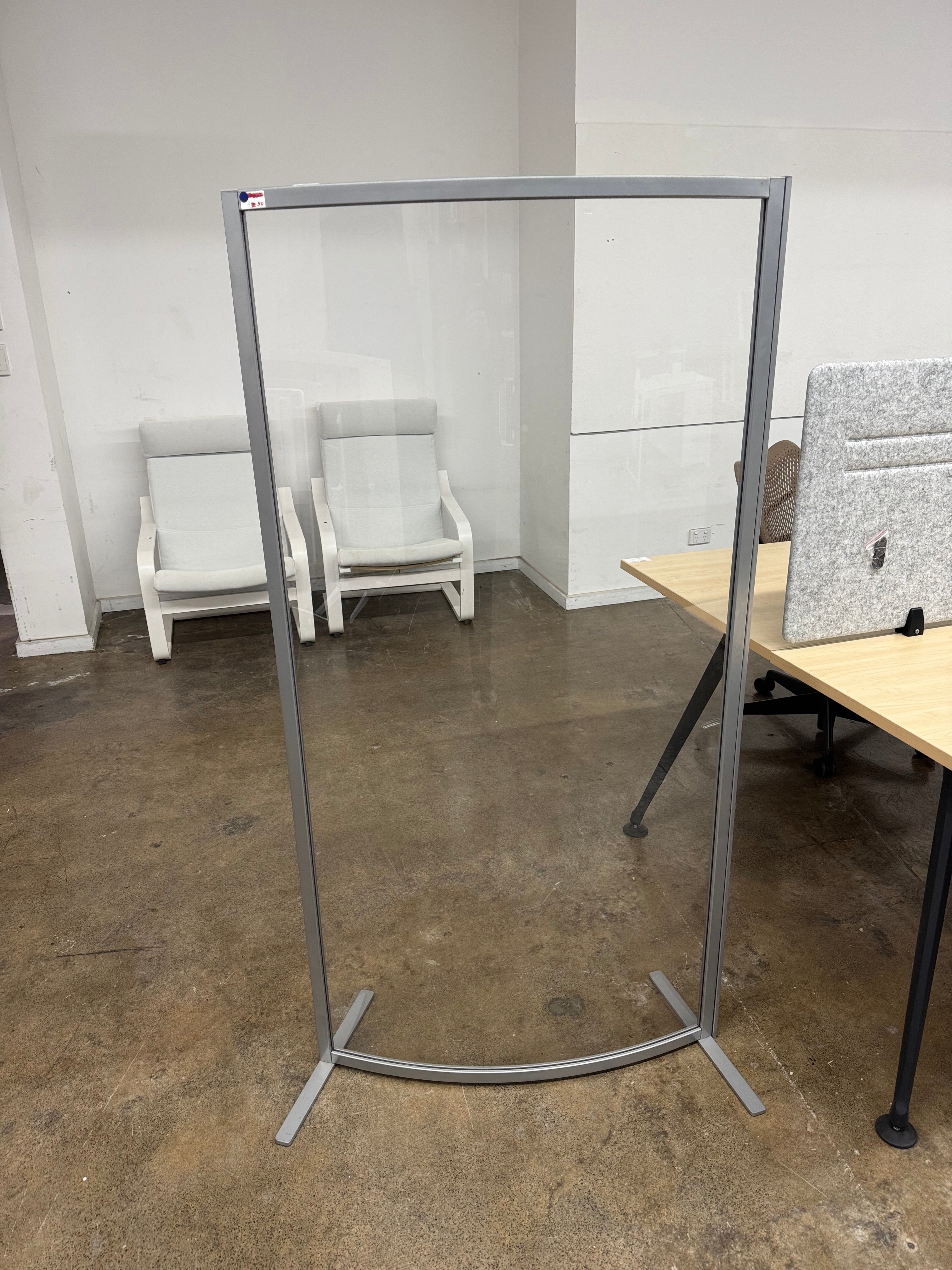 Clear plastic screen with metal frame in an office setting