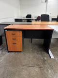 Wooden office desk with black frame in an indoor setting